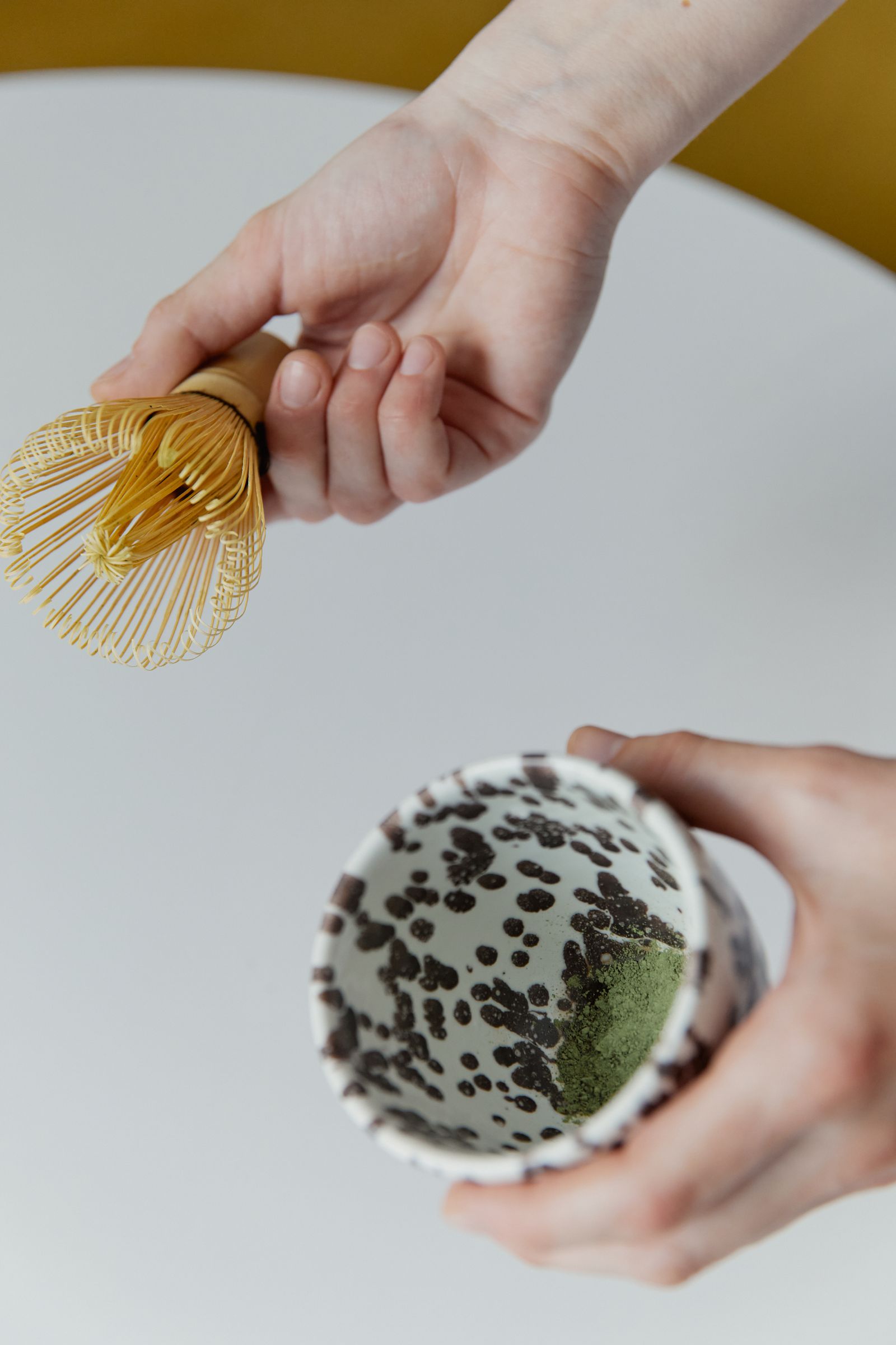 A bamboo whisk and a bowl of stone-ground matcha powder