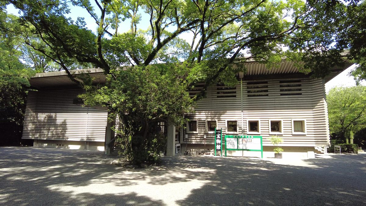 The long, low wooden Treasure Hall (Bunkaden) nestled among the shrine's green forest.