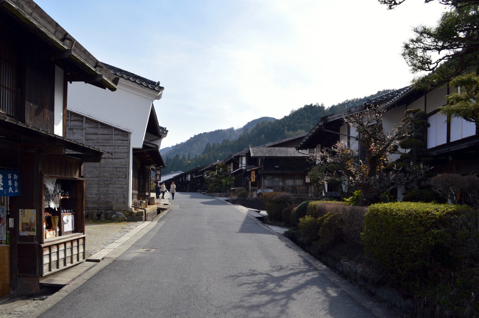 The level, beautifully preserved main street of Tsumago, dark timber inns under deep eaves
