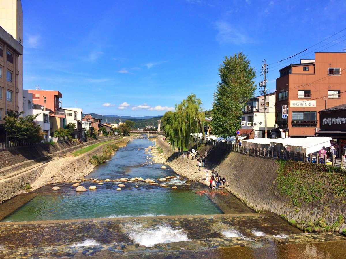 The Miyagawa river flowing through town, with willows and distant peaks