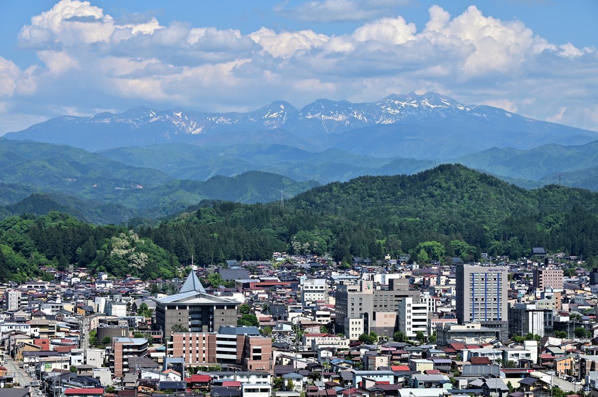 Takayama town spread below the snow-streaked Hida mountains
