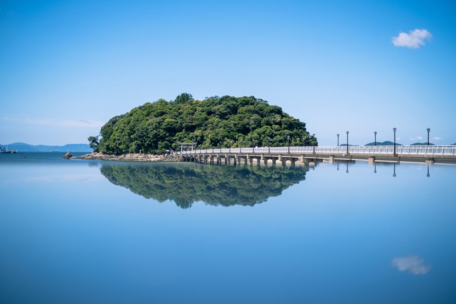Takeshima seen from the Gamagori shore, a green island on the calm waters of Mikawa Bay.